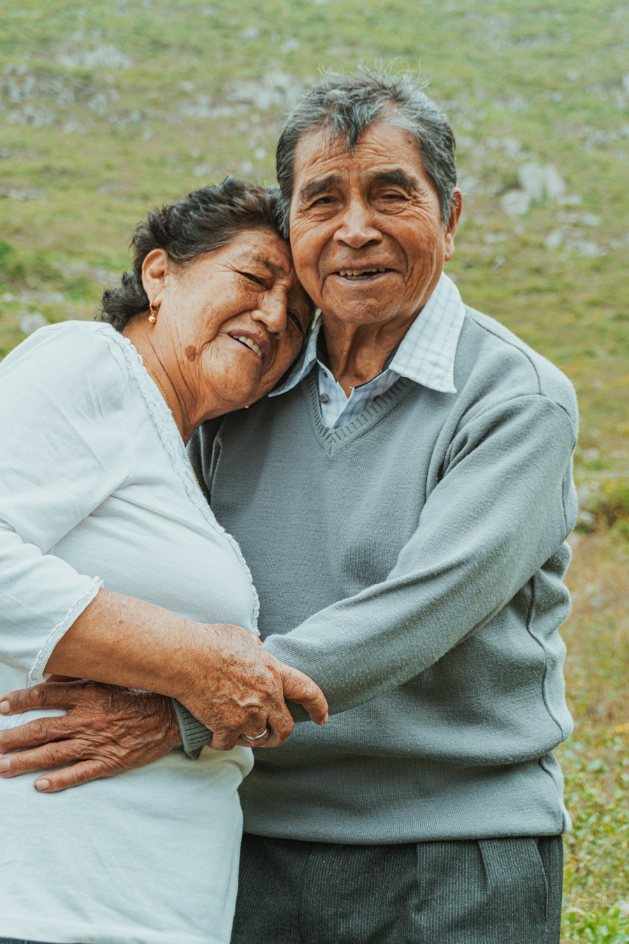 An older couple leaning affectionately together